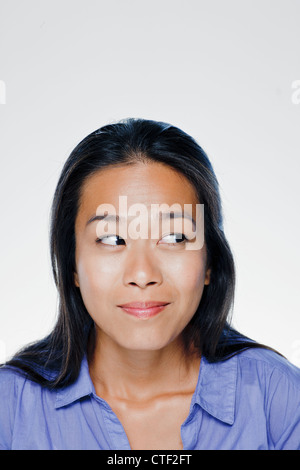 Portrait of smiling young woman, studio shot Stock Photo