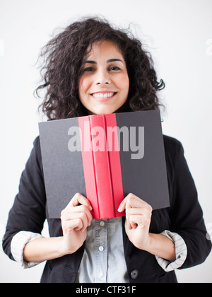 Happy young woman posing with book Stock Photo