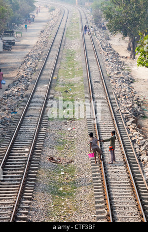 Boy and girl on railroad tracks in Mandalay, Myanmar Stock Photo