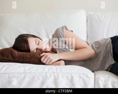 Young woman sleeping on sofa Stock Photo