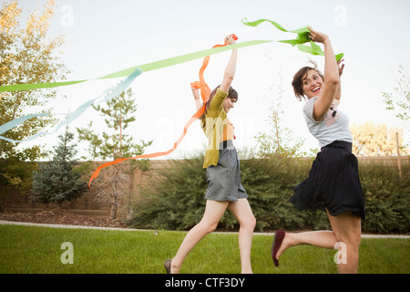 USA, Utah, Salt Lake City, Two happy female friends playing in domestic garden Stock Photo