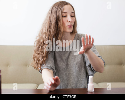 USA, Utah, Salt Lake City, Young woman painting fingernails Stock Photo