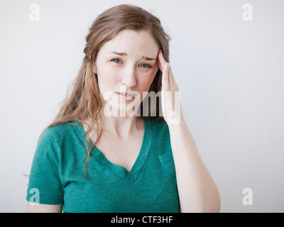 Studio shot of young suffering from headache Stock Photo