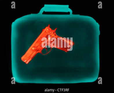 X-ray image showing handbag containing pistol Stock Photo