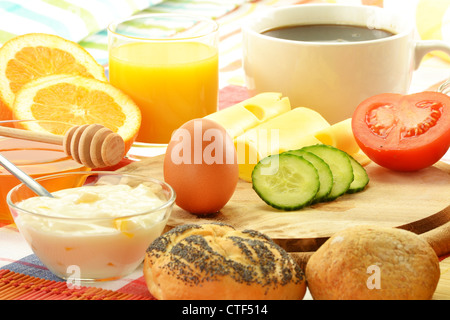 Breakfast including rolls, egg, cheese, coffee and orange juice on the table Stock Photo