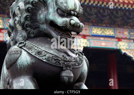 Male Lion guards the entrance to the halls in the Forbidden city, Beijing, China. Chinese Lion, a symbol of wealth, prosperity , Stock Photo