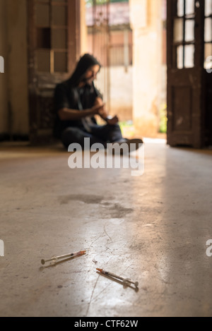 Heroin junkie shooting up drugs with syringe. Low angle view, copy space Stock Photo