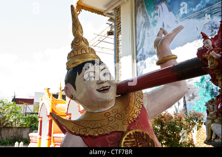 Laughing bell bearer, Dhammikarama Burmese Temple, Georgetown, Penang, Malaysia. Stock Photo