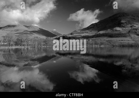 Black and White image of Whiteless Pike fell reflected in Crummock Water, Lake District National Park, Cumbria County, England Stock Photo