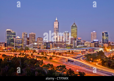 The sparkling centre of Perth, Western Australia, at dusk, under a clear sky, with traffic on the freeway. Stock Photo