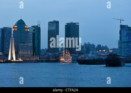 Shanghai skyscrapers near water at night with mirror Stock Photo