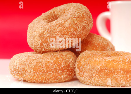 Freshly baked apple cinnamon doughnuts with coffee Stock Photo