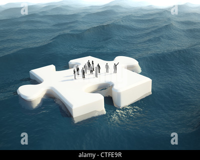 A group of tiny people on a puzzle piece shaped ice float Stock Photo