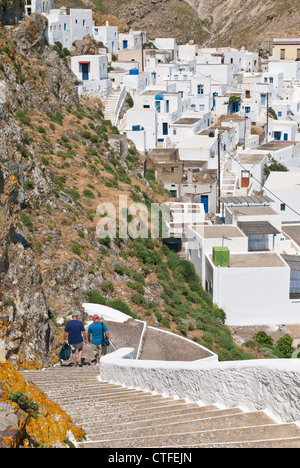 People walking down steps in the whitewashed Hora of Serifos Island, Greece Stock Photo