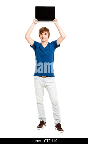 Handsome young man holding a laptop isolated over a white background Stock Photo