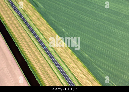 The Netherlands, Zeewolde, Cars on road in Flevopolder. aerial. Stock Photo