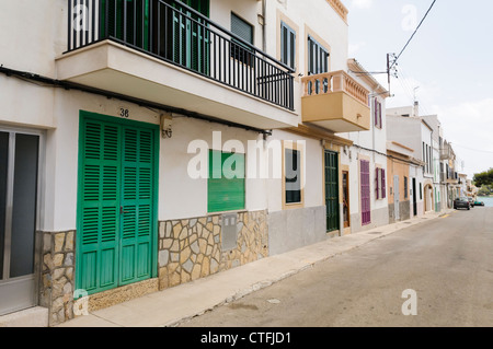 Houses with shutters over the windows on an empty street in Spanish town of Portocolom, Mallorca/Majorca Stock Photo