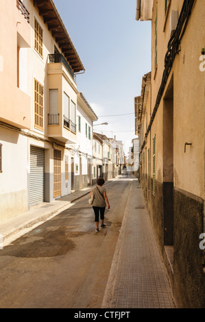 Woman walks down a street in Manacor, Mallorca/Majorca Stock Photo