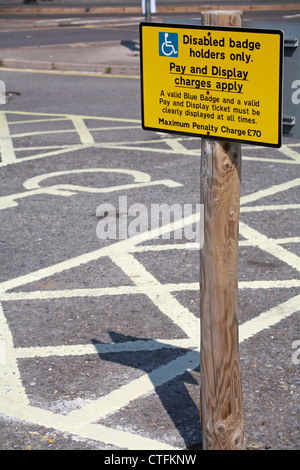 disabled car parking bay with blue badge parking details notice at Weymouth, Dorset UK in May Stock Photo