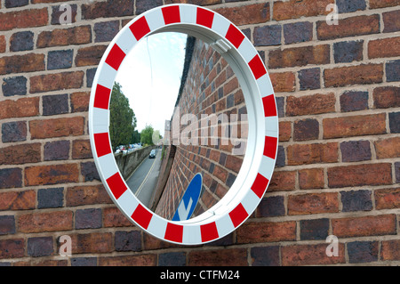 Convex mirror at difficult road exit, Castle Lane, Warwick, Warwickshire, England, UK Stock Photo