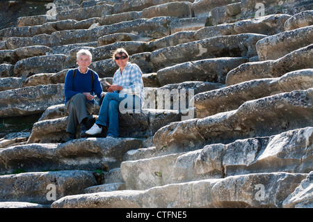 Newly retired British couple emigrated to Turkey. Visiting the archaeological sites with guide book in hand. Stock Photo