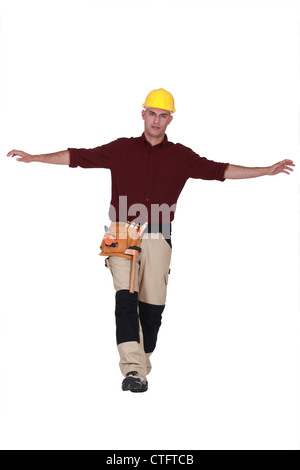 craftsman isolated on white trying to keep his balance Stock Photo