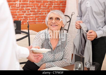 Couple paying a bill in a restaurant Stock Photo