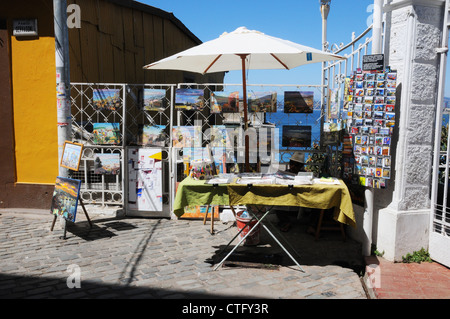 Street seller, paintings, post cards, on street, Valparaiso, Chile. Stock Photo