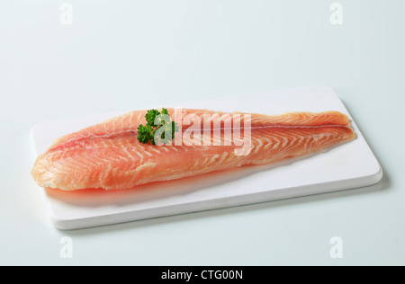 Raw fish fillet on cutting board Stock Photo