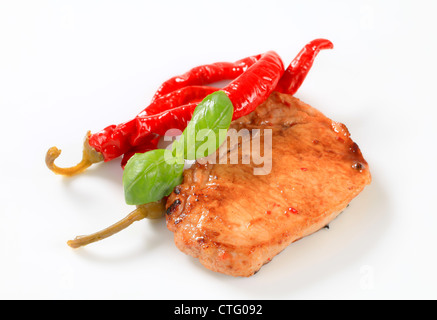 Pan-fried pork chop with pickled chili peppers Stock Photo