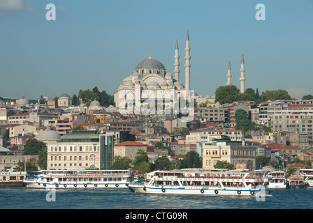 ISTANBUL, TURKEY. Bosphorus ferries on the Golden Horn, with the Suleymaniye mosque dominating the skyline. 2012. Stock Photo