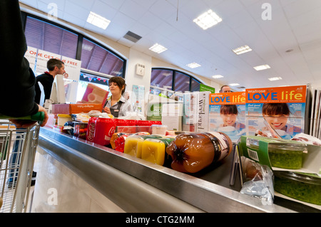 Waitrose supermarket checkout till as food products move along the belt ...