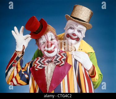 1970s PORTRAIT OF TWO SMILING CLOWNS LOOKING AT CAMERA Stock Photo