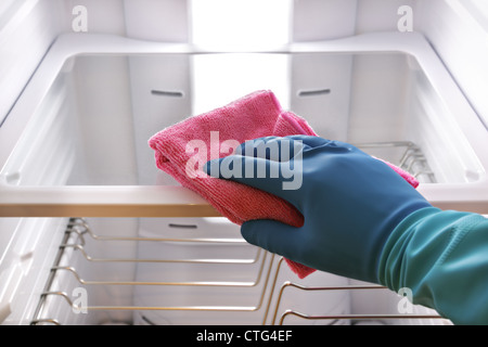 Hand cleaning refrigerator Stock Photo