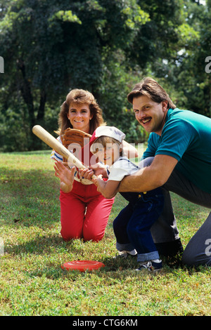 PARENTS AND CHILD PLAYING BASEBALL Stock Photo