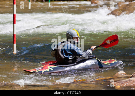 Whitewater kayaker maneuvering kayak in rapids at the Nantahala Outdoor Center in North Carolina Stock Photo