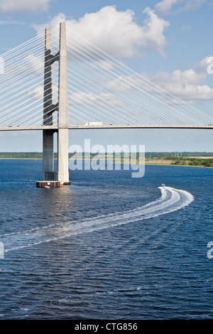 Commercial boat passes under the Dames Point Bridge on the St. Johns River in Jacksonville, FL Stock Photo