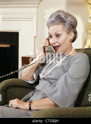 1960s SENIOR WOMAN TALKING EXCITED FACIAL EXPRESSION ON TELEPHONE RETRO Stock Photo