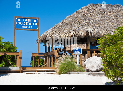 Sign at beach entrance next to shopping hut on beach at Half Moon Cay, Bahamas Stock Photo