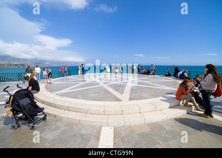 People relaxing at the end of Balcon de Europa promenade on Costa del Sol in Andalusia, Spain. Stock Photo