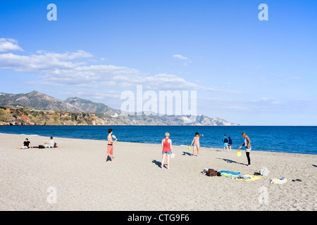 Group of teenagers having fun on a beach by the Mediterranean sea in Nerja, Costa del Sol, Spain. Stock Photo