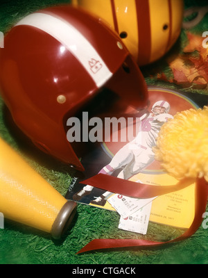 1970s AMERICAN FOOTBALL STILL LIFE HELMET MEGAPHONE TICKETS POSTER HOMECOMING FLOWER MUM SOFT FOCUS Stock Photo