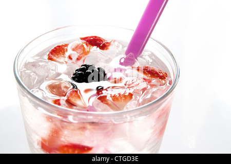 Summer fruit drink in a glass with ice and berries. Stock Photo