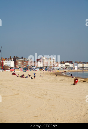 Enjoying the beach at Weymouth on a sunny day in May Stock Photo