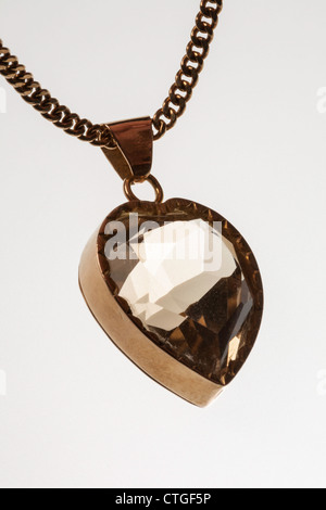 Topaz Gemstone in Vintage Heart-shaped Gold Pendant Stock Photo