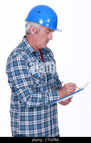 Tradesman taking notes Stock Photo