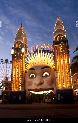 The entrance to Luna Park funfair at night, with the grinning face and ferris wheel Milsons Point Sydney NSW Australia Stock Photo