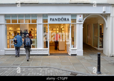 Window shopping & shoppers inside a Pandora shop which sells customizable jewellery City of Chester Cheshire England UK Stock Photo
