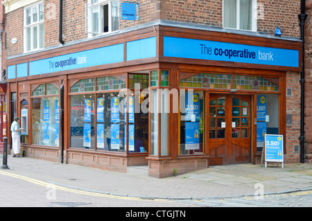 Co op high street bank branch with customer using ATM machine on corner site in Chester Cheshire England UK Stock Photo