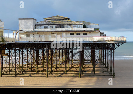 The decaying Victoria Pier on the beach at Colwyn Bay Stock Photo